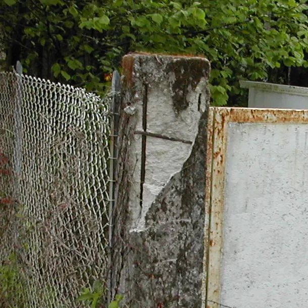 Spalling concrete exposing reinforcement