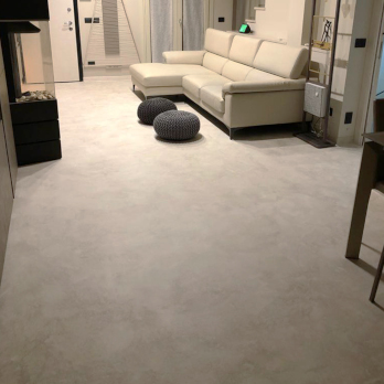 Living room floor continuously covered with warm gray Microbond microcement