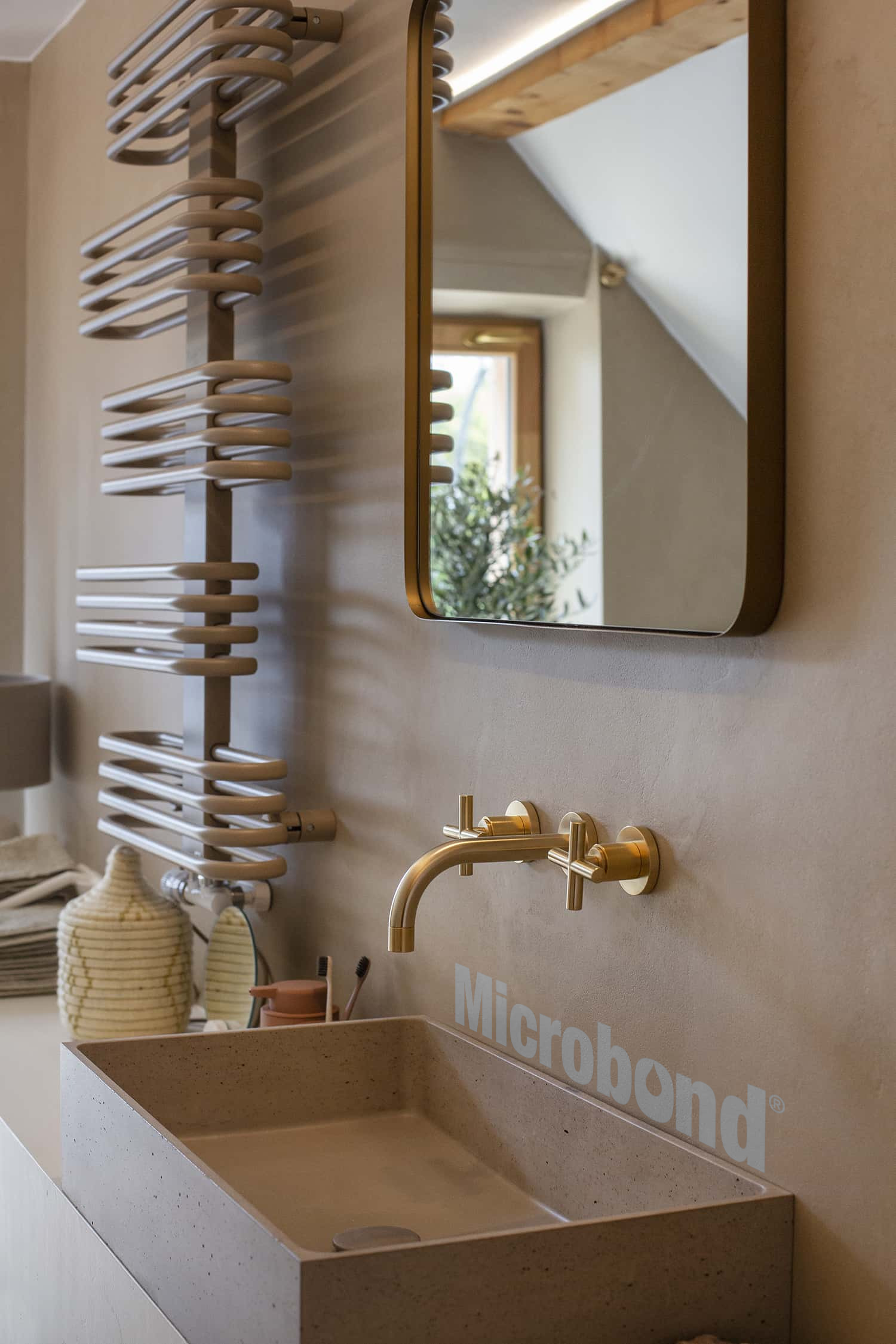 Bathroom walls covered with Microbond microcement, colored to match the stone sink
