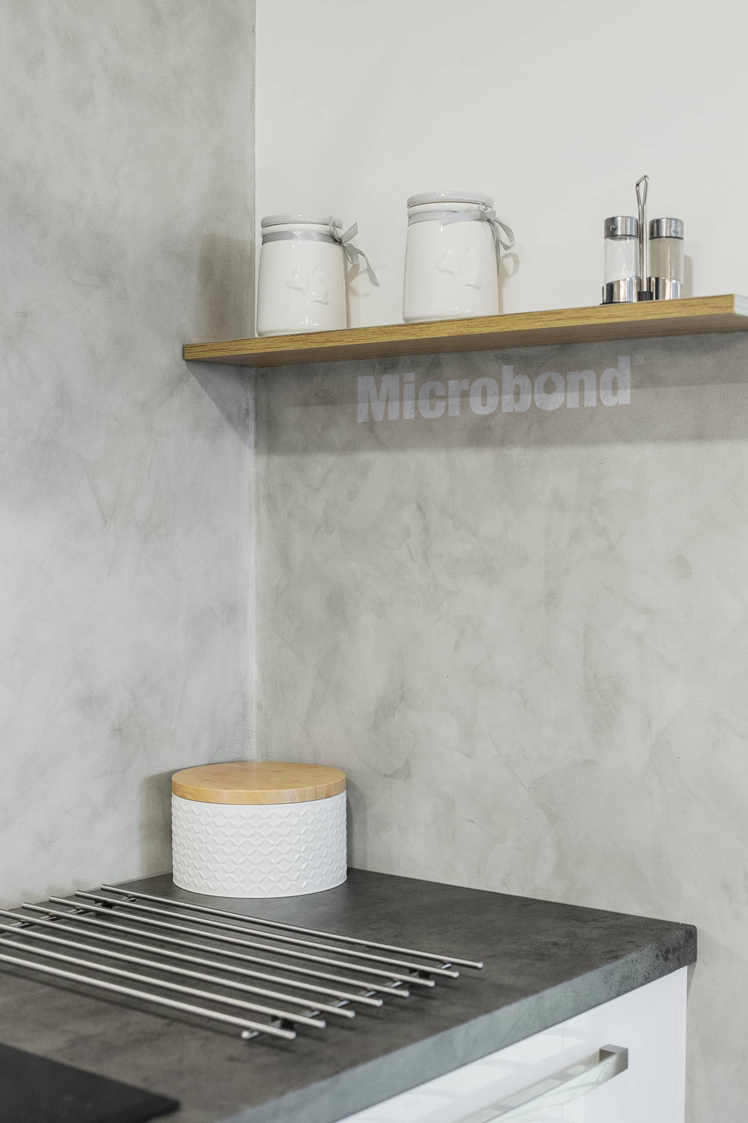 A more elaborate and expressive microcement on a wall, with cloudy shades of grey
