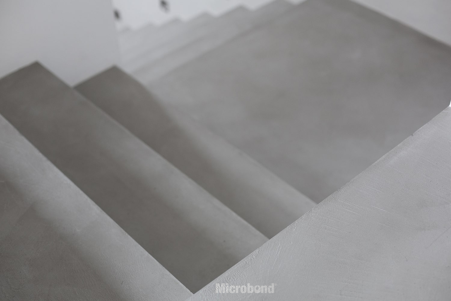 Close-up view of a staircase covered with gray Microbond