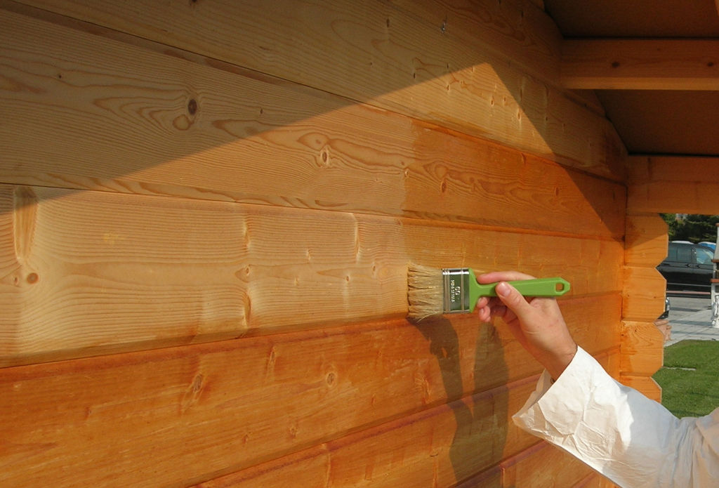 Application by brush of Everwood in a wooden garden house